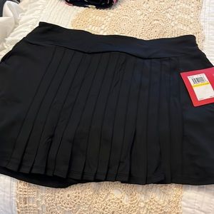 Brand new. Never worn black pleated fila tennis skirt!